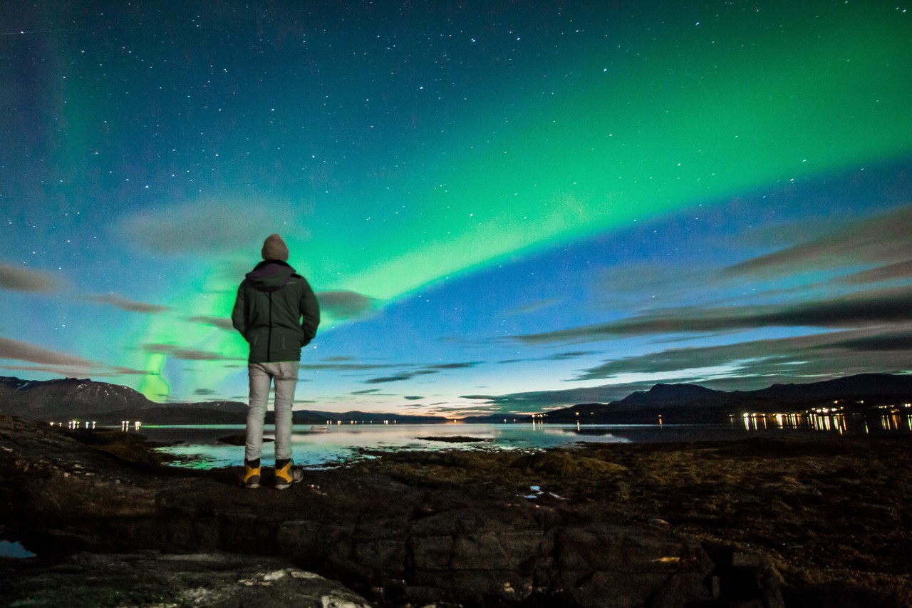 adult-watching-aurora-borealis-hvammstangi
